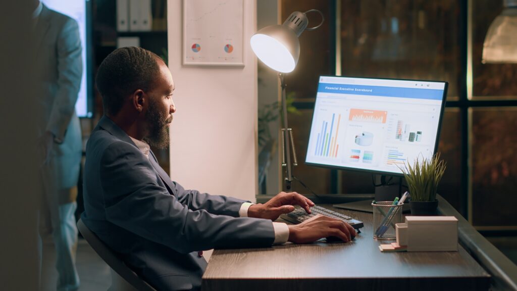 Employee working on payroll reports Employee working on payroll reports